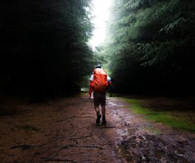 man with the backpack walking in the rain